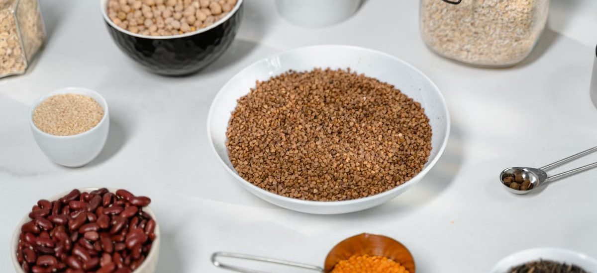 A collection of grains and legumes in various bowls and jars, perfect for culinary inspiration.
